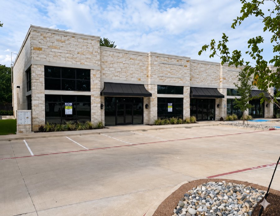 Bear Family Dental building exterior in light masonry with a dark storefront system