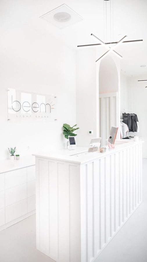 Beem Light Sauna reception in white joinery with a rounded ceiling detail