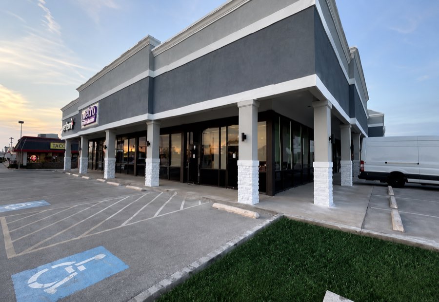 Duncanville Shopping Center photographed at dusk, with a stucco parapet and colonnade
