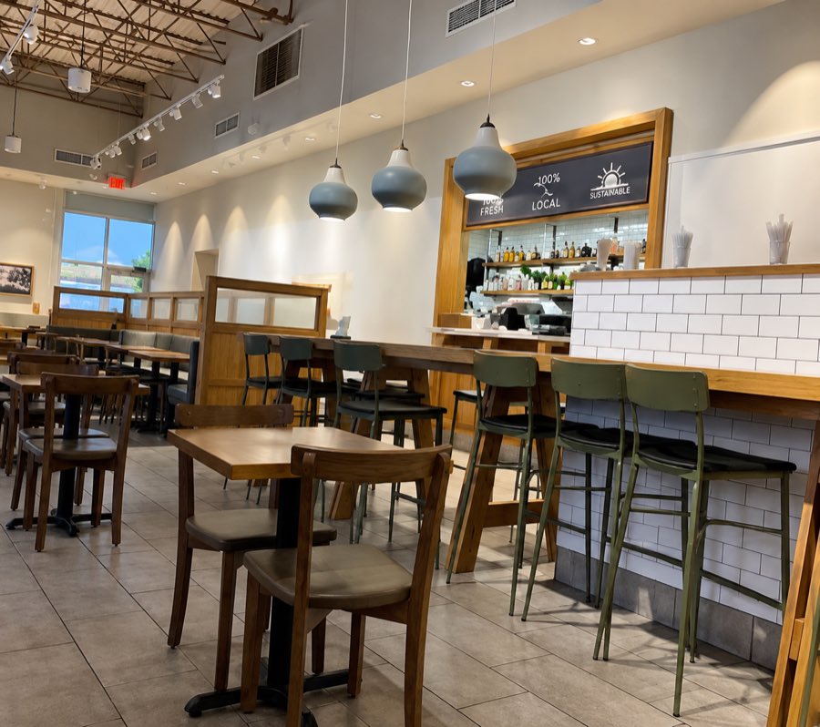 Panera Bread dining room with pendant lighting, timber banquettes and a tiled service counter