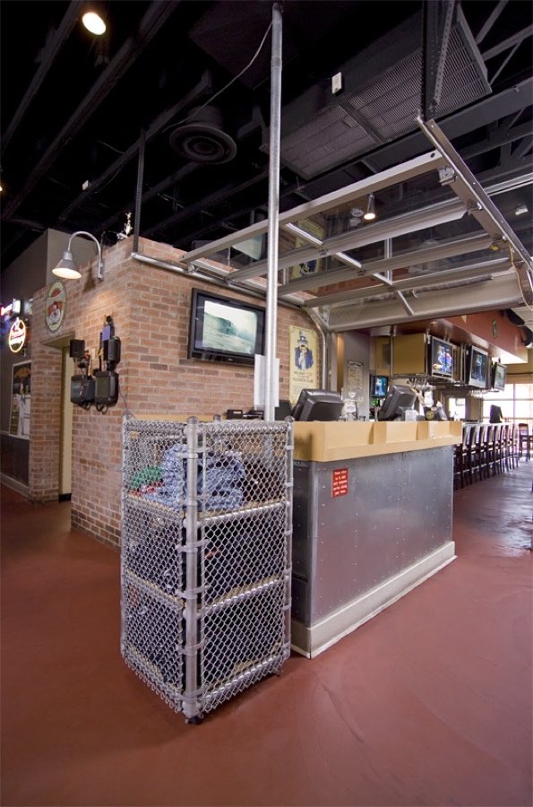 Pluckers Wing Bar interior with brick walls, wall-mounted screens and a service counter