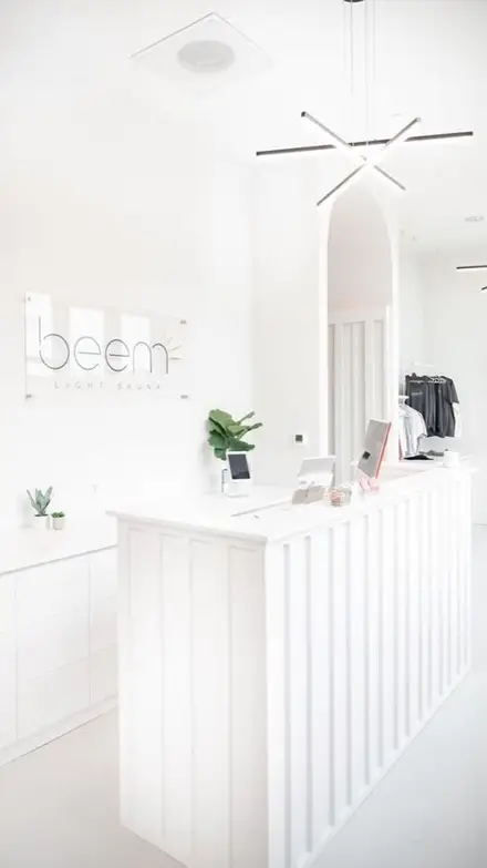 Beem Light Sauna reception in white joinery with a rounded ceiling detail