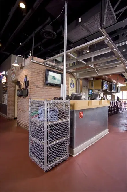 Pluckers Wing Bar interior with brick walls, wall-mounted screens and a service counter